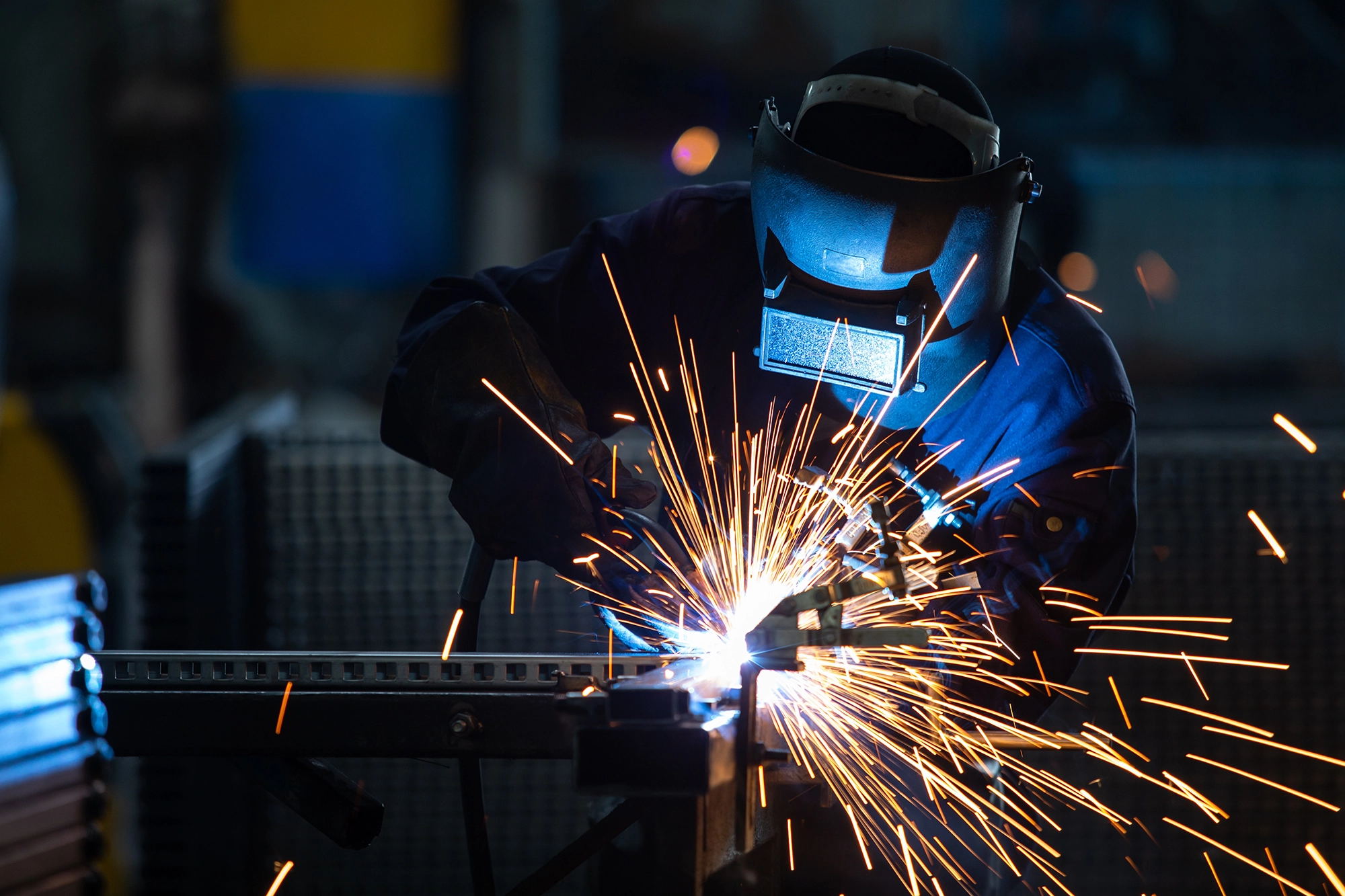 Welder at work with sparks